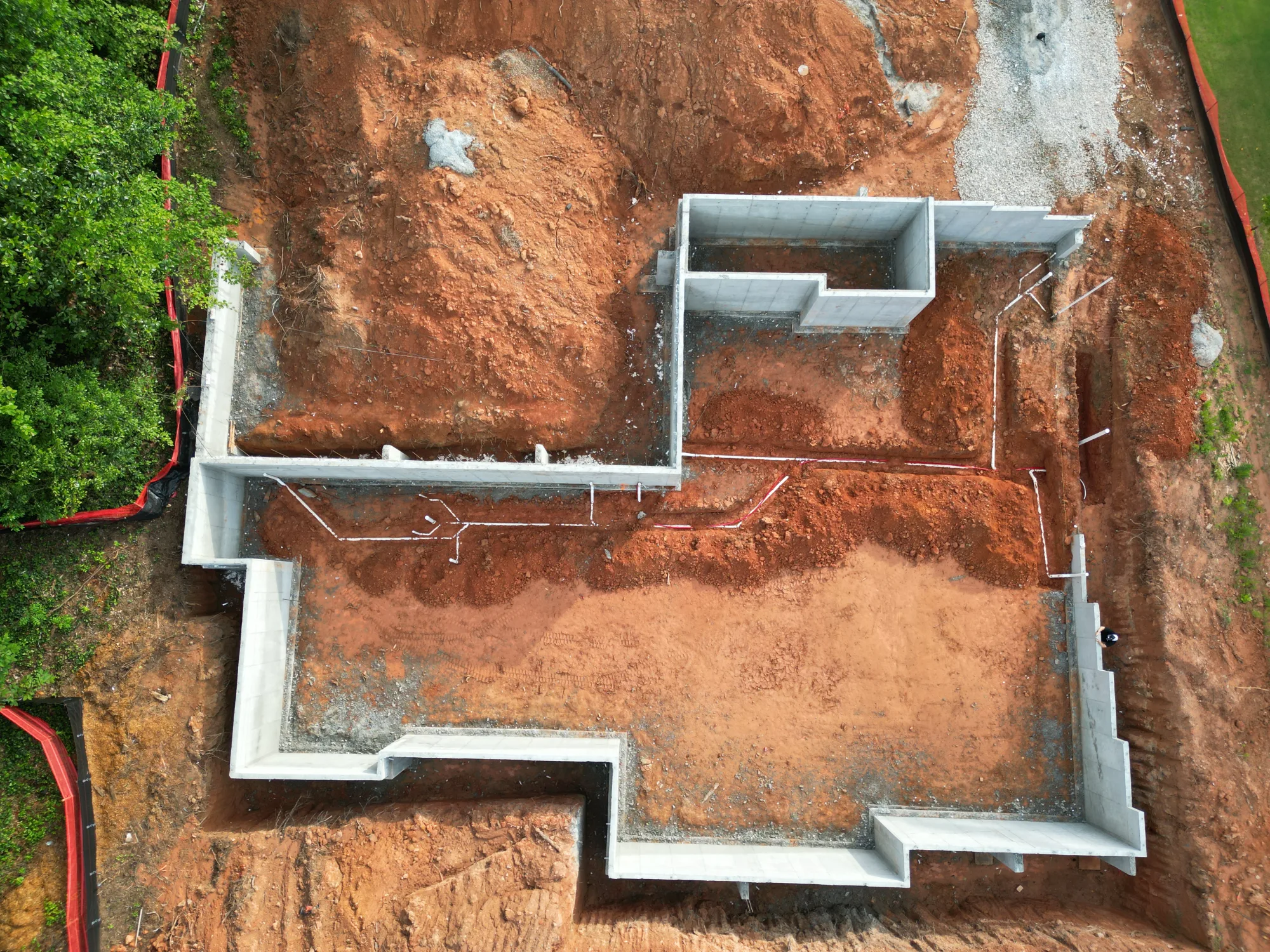 Aerial overview of custom home foundation construction