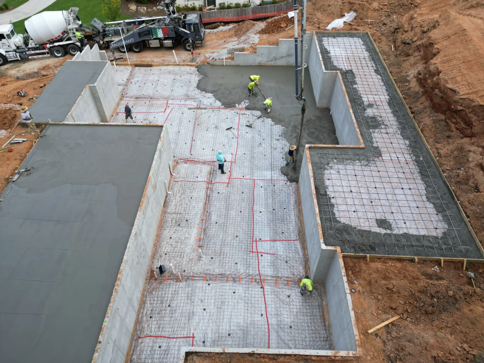 Floor framing begins on custom home foundation